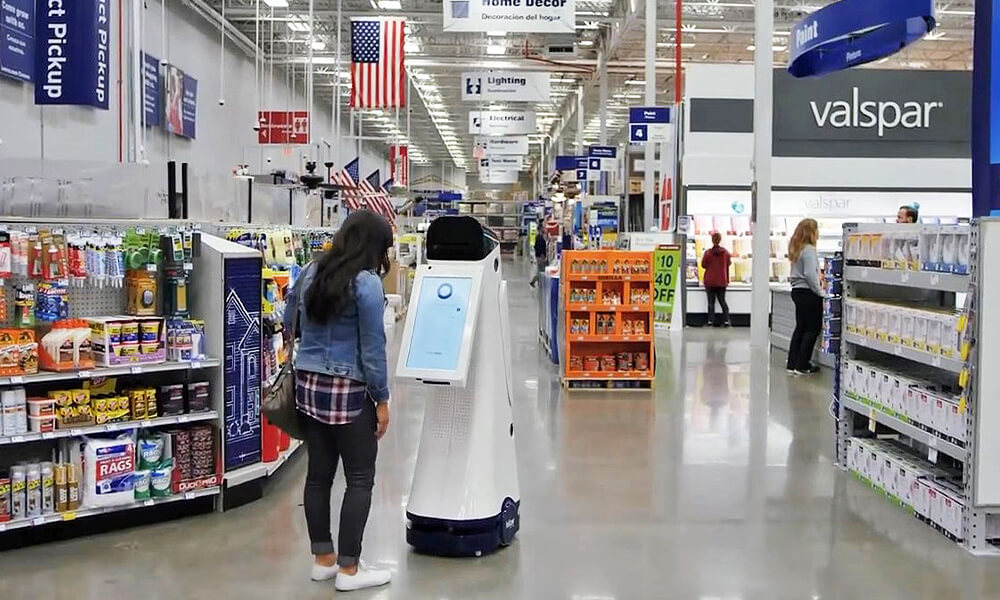 Female customer in a Lowe's Home Improvement store using the LoweBot to search for a product.
