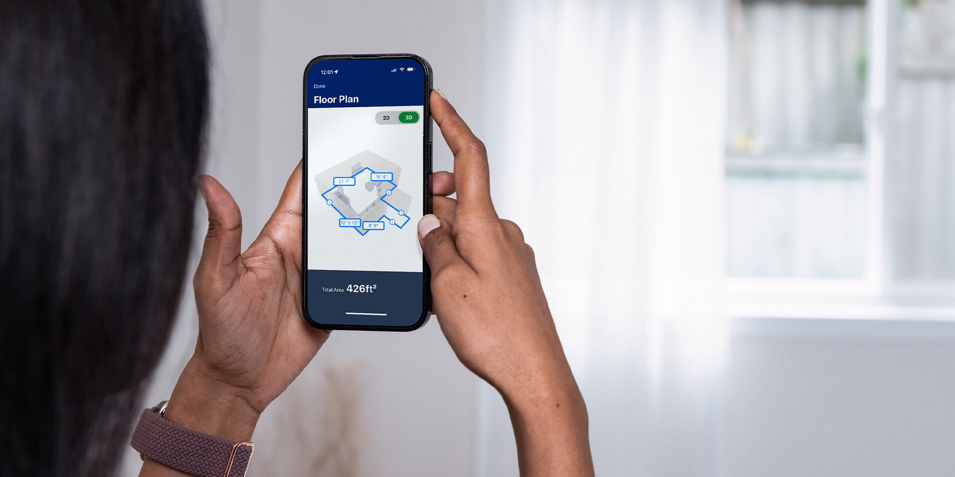 Female measuring bedroom walls with Lowe's Innovation Labs Measure Your Space experience through the Lowe's Home Improvement mobile app.